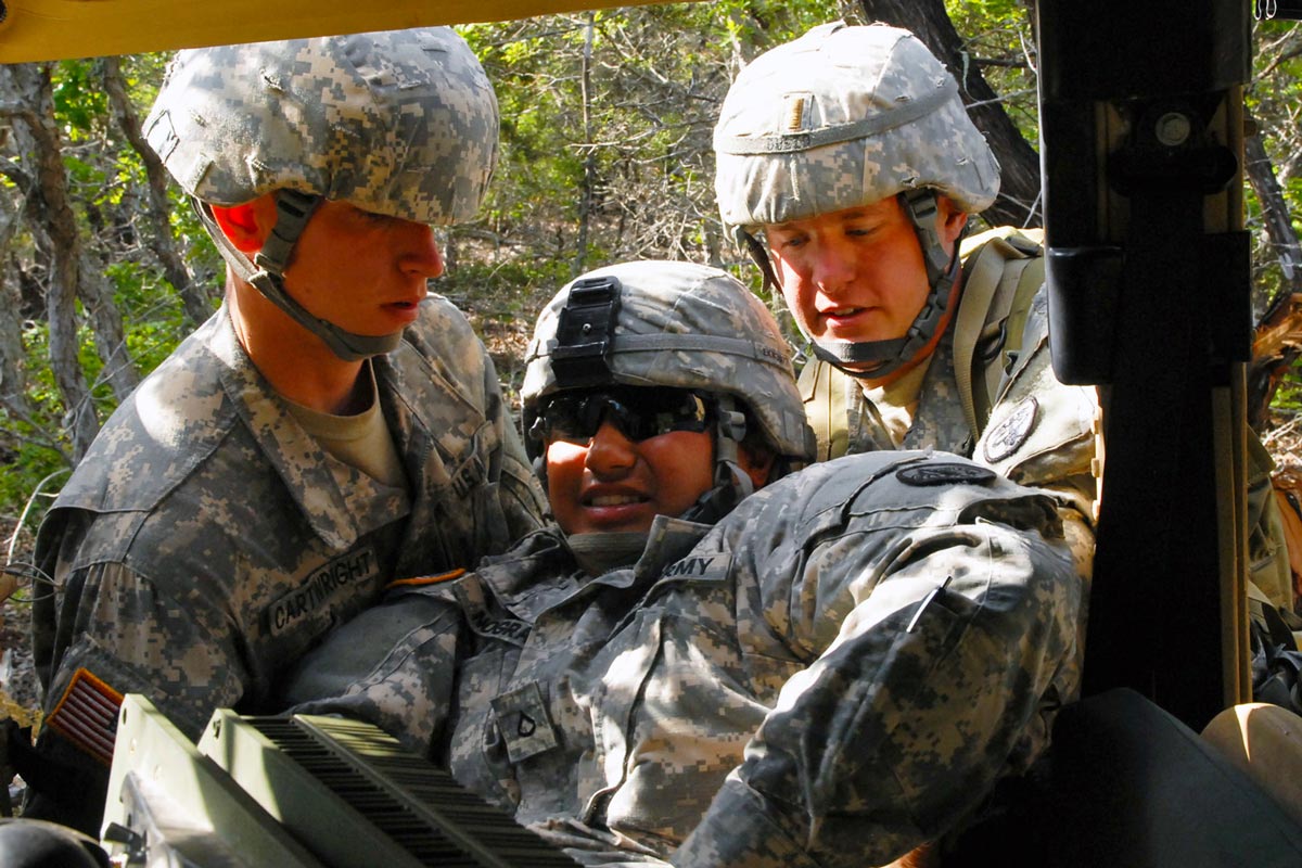 extricates a simulated casualty from a humvee during EFMB testing