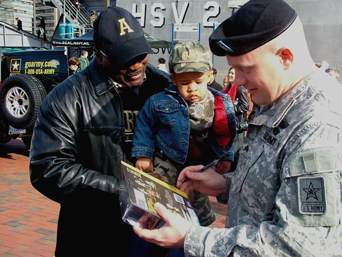 Sgt. Tommy Rieman signs his action figure