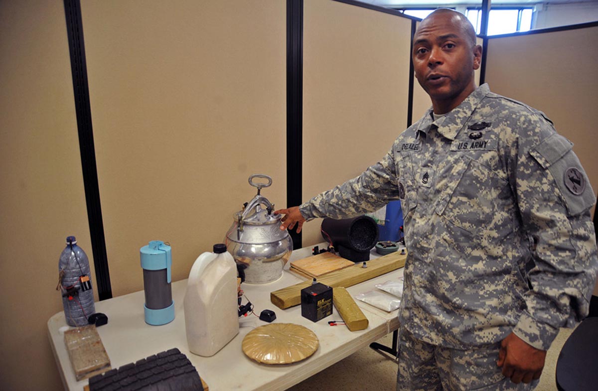 Sgt. 1st Class Kindu Delaleu, noncommissioned officer in charge for the Asia-Pacific Counter-Improvised Explosive Device Center, points out some of the IED devices Soldiers can be forced to deal with in the Asia-Pacific area.