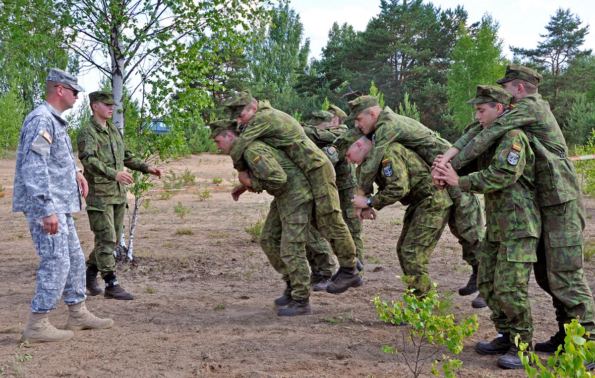 Sgt. Terry Selert of the Pennsylvania National Guard looks to a Lithuanian soldier during a joint live-fire exercise