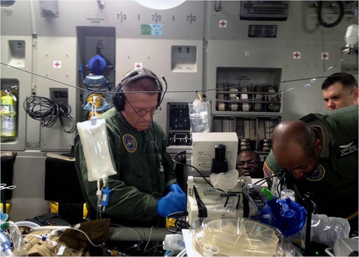 From left, Capt. Michael Campbell, Lt. Col. (P) Booker T. King, Sgt. Nikenson Penette and Staff Sgt. Daniel J. Nelson monitor a patient during a flight from Singapore to San Antonio.