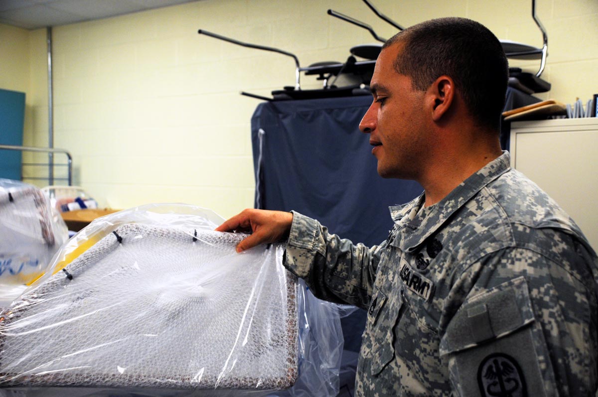 Sgt. 1st Class Hugo Roman, the NCOIC for burn occupational therapy, discusses the slings and nets developed by the research team to keep extremities in certain positions as they heal.