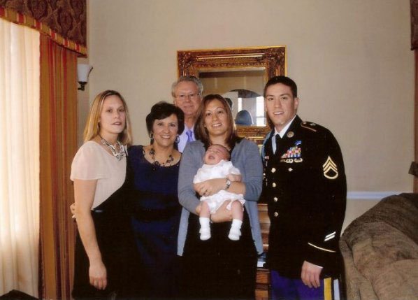 Staff Sgt. Michael H. Ollis, the godfather to the baby in this photo, poses with family members, including his sister and her baby, and his parents, Linda and Robert Ollis. (Photo courtesy of Ollis family)