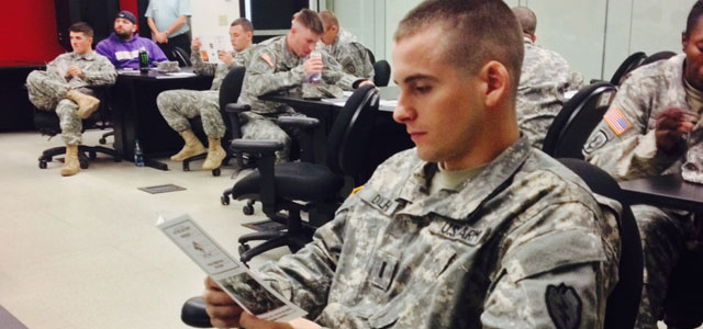 Army 1st Lt. Craig Dolhi, a platoon leader with 5th Squadron, 1st Cavalry Regiment, 1st Stryker Brigade Combat Team, 25th Infantry Division, reads over information during the Army’s Ask, Care and Escort suicide intervention training Oct. 2-4, 2013.  (Photo by Capt. Patrick Bracken)