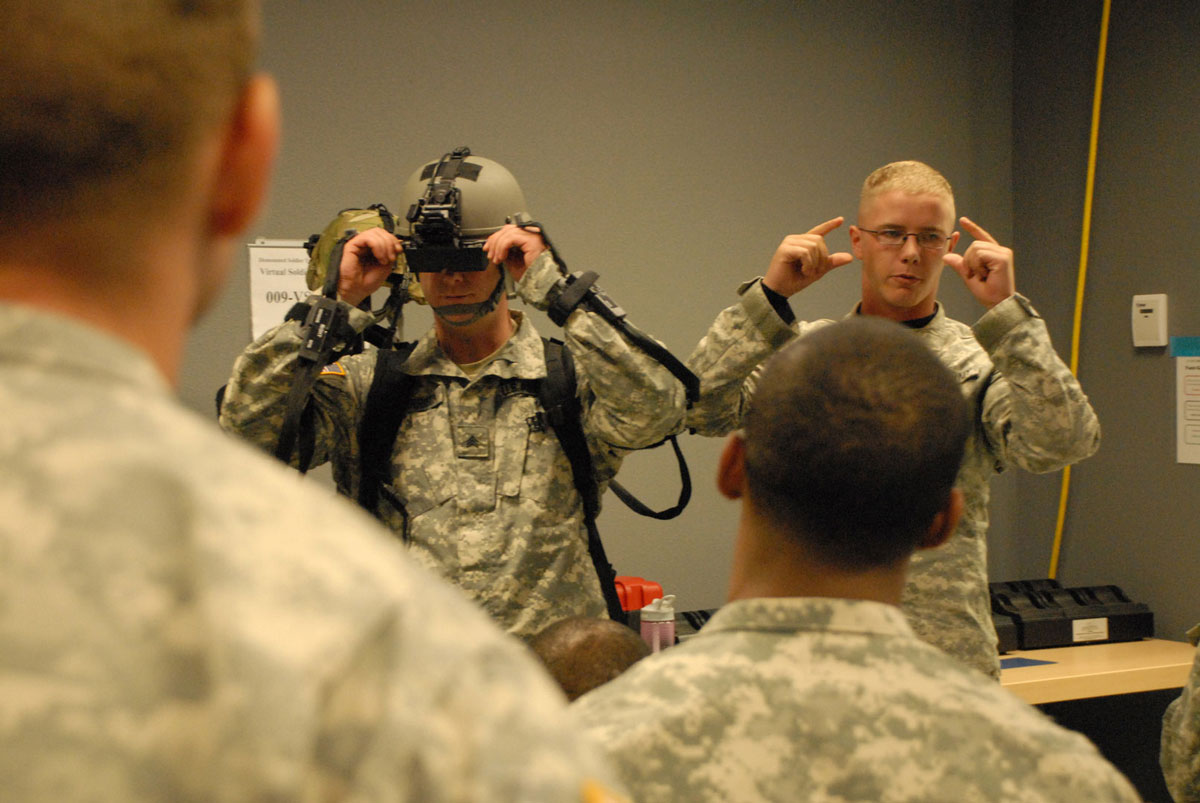 Sgt. David Harrison, left, and Spc. Eric Smit of A Company, 72nd Brigade Support Battalion, 212th Fires Brigade, instruct members of their company how to set up and use the Dismounted Soldier Training System during a training exercise at Fort Bliss, Texas. (Photo by Jonathan (Jay) Koester, NCO Journal)