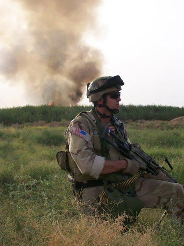 Then-Sgt. 1st Class Michael Lindsay kneels after a firefight that re-took a village in Iraq. (Photo
courtesy Master Sgt. Michael Lindsay)