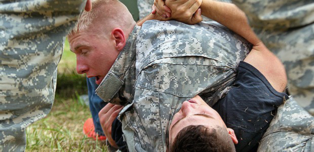 Sgt. Nicholis Couture, U.S. Army Europe’s NCO of the Year, tackles a role-player in the react to man-to-man contact lane Tuesday during the 2014 U.S. Army Best Warrior Competition at Fort Lee. (Photo by Staff Sgt. Patricia Ramirez)