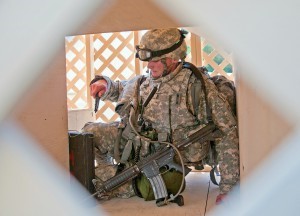 Spc. Keegan Carlson, the U.S. Army Reserve’s Soldier of the Year, navigates through the ‘Fun Box’ obstacle Tuesday during the 2014 U.S. Army Best Warrior Competition at Fort Lee, Va. (Photo by Sgt. 1st Class Andy Yoshimura)