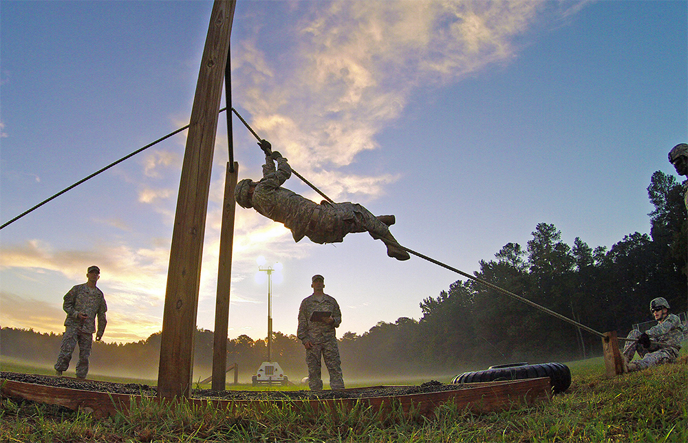 Spc. Ryan Montgomery, the National Guard Bureau’s Soldier of the Year, navigates a portion of the Leadership Reaction Course on Wednesday during the 2014 U.S. Army Best Warrior Competition at Fort Lee, Va. The NCO of the Year competitors tackled the course on Thursday. (Photo by Staff Sgt. Adam Fischman)