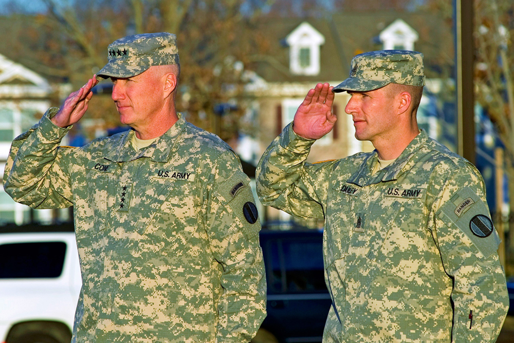 Gen. Robert W. Cone, commanding general of U.S. Army Training and Doctrine Command, and Command Sgt. Maj. Daniel A. Dailey, TRADOC’s command sergeant major, salute the colors as the flag is lowered during Dailey’s welcome ceremony at Fort Eustis, Va., in December 2011. (Photo by Sgt. Angelica Golindano)