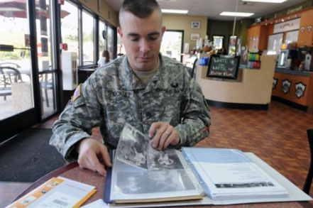 Sgt. 1st Class James Shockley looks through a binder containing case files for Pvt. Richard Clapp, a Soldier who died in 1950 in the Korean War. Shockley was assigned as a casualty assistance officer to Clapp’s surviving next of kin after the Soldier’s remains were positively identified 62 years after his death. (Photo by Sgt. Mark Miranda)