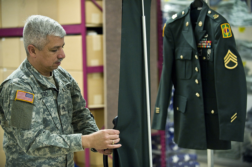 Sgt. 1st Class Jimmy Toro, a mortuary affairs specialist assigned to the Casualty and Mortuary Affairs Operations Center, U.S. Army Human Resources Command at Fort Knox, Ky., steam cleans the uniform of a fallen Soldier during preparation for the dignified transfer of remains. (Photo by Staff Sgt. Bennie J. Davis)