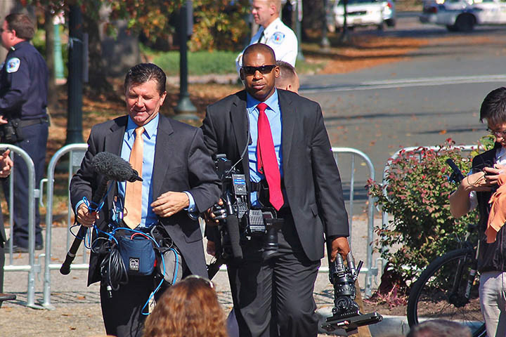 A WHCA NCO, center, carries camera equipment during an event at the White House. (Photo courtesy of WHCA)