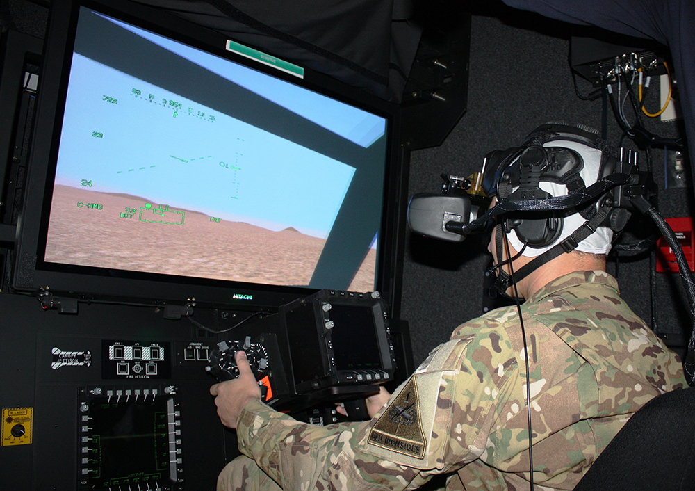 A 1st Armored Division Soldier trains on the Aviation Combined Arms Tactical Trainer, at Fort Bliss, Texas. The exercise combined live, virtual and constructive training as part of the Integrated Training Environment. The Integrated Training Environment is evolving to a single synthetic environment that combines constructive, gaming and virtual systems and is coupled with live training. (Photo by Mike Casey)