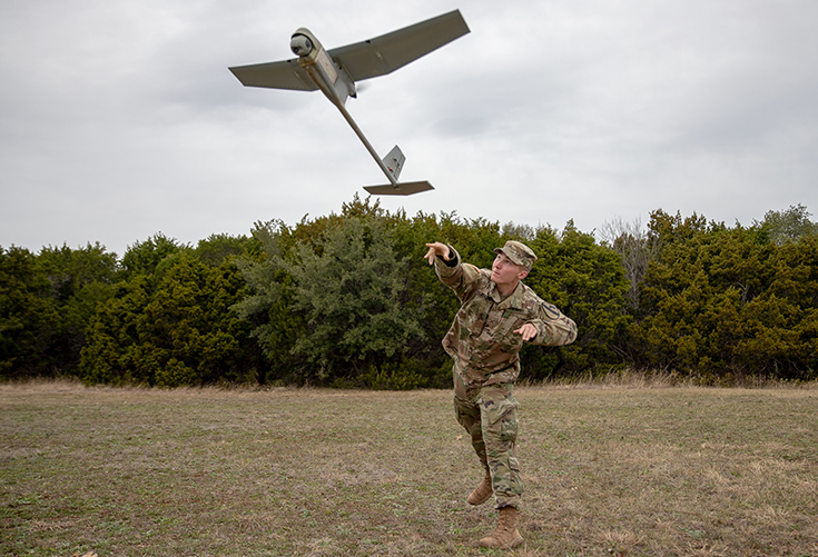 U.S. Army Pvt. Thrush Beazer launches a RQ-11 Raven unmanned aerial system during the basic operator's training course at Fort Hood, Texas, Dec. 12, 2018.