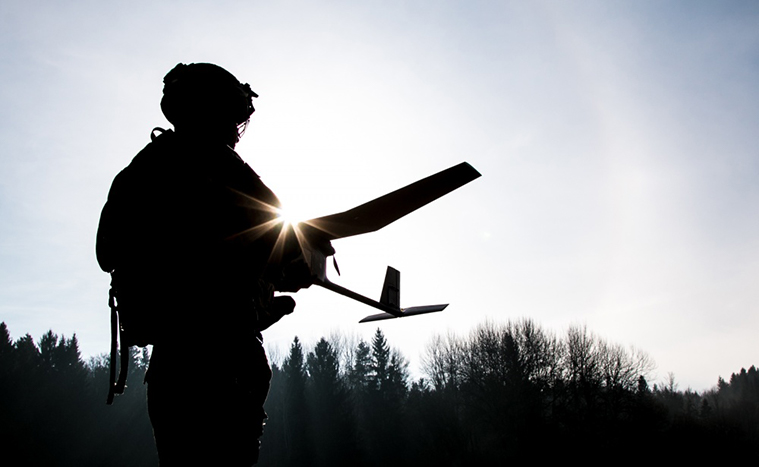 Spc. William Ritter prepares to launch a RQ-11B Raven