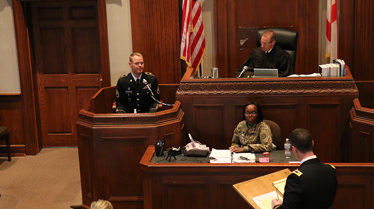 Mississippi Army National Guard Maj. Jonathan Bullock (far right), a Trial Defense Council, questions the accused during the 4th annual 167th Theater Sustainment Command mock court martial, August 2, 2018