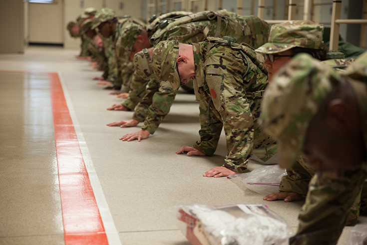 U.S. Army trainees assigned to Foxtrot 1st Battalion, 34th Infantry Regiment conduct push-ups for corrective training in the barracks