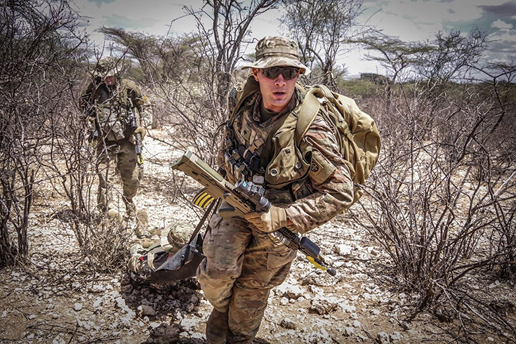 Paratroopers with 508th Parachute Infantry Regiment, 3rd Brigade Combat Team, 82nd Airborne Division, provide emergency medical care to a simulated casualty during a live-fire exercise alongside British paratroopers