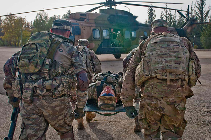 U.S. and Turkish Soldiers carry a simulated casualty to a helicopter during rehearsals