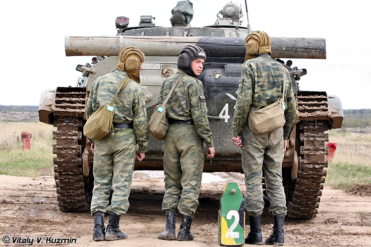 Russian soldiers from 4th Guards Kantemirovskaya Tank Division stand behind their BMP-2 Infantry Fighting Vehicle during the annual inspection