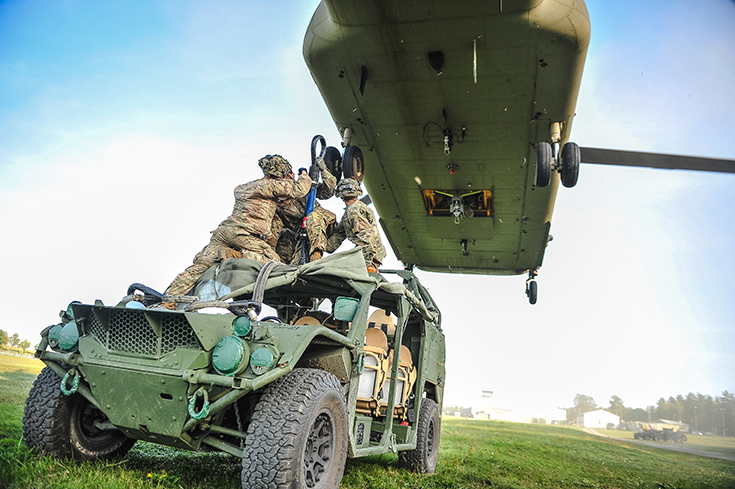 U.S. Army paratroopers assigned to the 173rd Airborne Brigade sling-load an Army Ground Mobility Vehicle