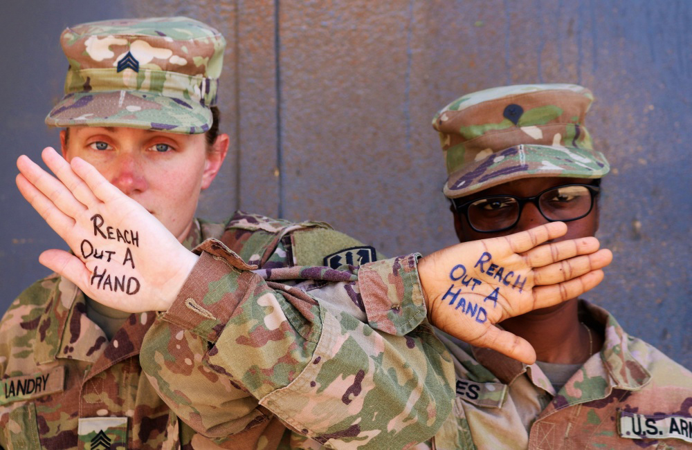 Sgt. Rebecca Landry and Spc. Asia Jones, 529th Support Battalion Soldiers and close battle buddies, assist with suicide prevention/intervention photos taken at Camp Taji, Iraq, June 5, 2019.