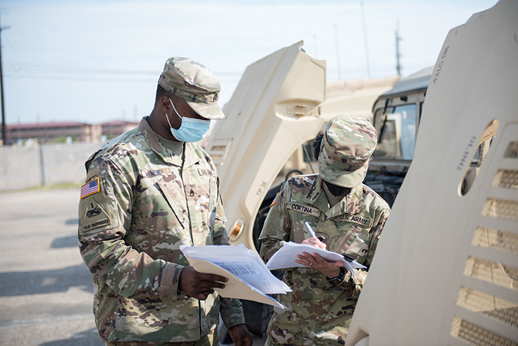 U.S. Army Staff Sgt. Logan Neely mentors Spc. Jessica Cortina