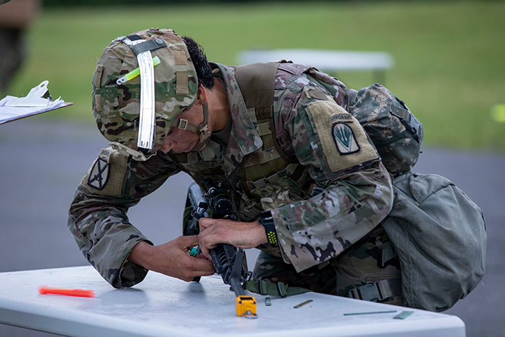 U.S. Army Sgt. 1st Class Adriana Fox disassembles her weapon.