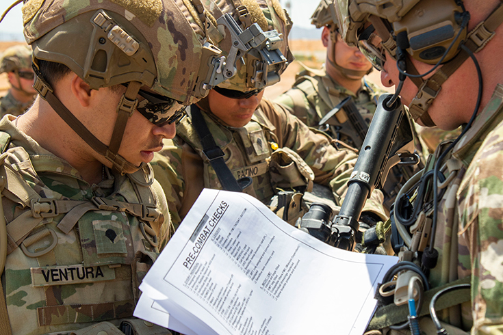 U.S. Army Sgt. Jordin Katzenberger, right, a squad leader with 1st Battalion, 178th Infantry Regiment conducts pre-combat checks with his Soldiers