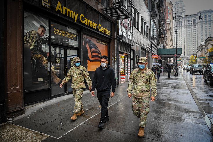 Manhattan recruiters talk with a potential recruit on the streets of New York City