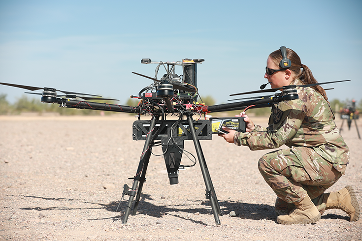 U.S. Army Staff Sgt. Elise Denning, assigned to Artificial Intelligence Integration Center, conducts maintenance on an unmanned aerial system in preparation for Project Convergence at Yuma Proving Ground, Arizona