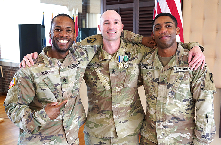 Staff Sgt. Matthew McQuade (center), religious support NCOIC, Religious Support Office, U.S. Army Garrison Fort Hamilton, N.Y., is celebrated by friends after being awarded the Army Commendation Medal and Army Achievement Medal