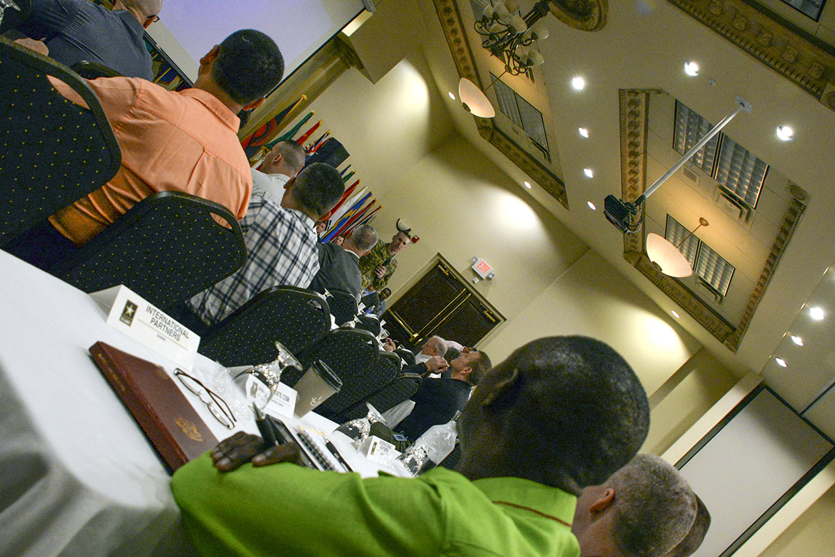 Chief Warrant Officer Dickson Owusu, foreground, the forces sergeant major of the Ghana Armed Forces, listens as Sgt. Maj. of the Army Daniel A. Dailey speaks April 13 in El Paso, Texas, during the second day of the International Training and Leader Development Symposium. The event was attended by U.S. senior enlisted leaders and their international counterparts from 55 countries in an attempt to reinforce the importance of a quality noncommissioned officer corps and to foster international parternships. (Photo by Clifford Kyle Jones)