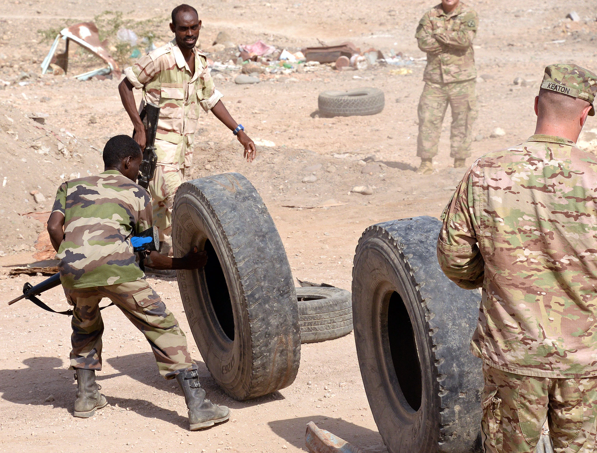 As Staff Sgt. Richard Keaton and other U.S. Army Soldiers look on, members of the Djiboutian army go through an exercise on dealing with roadblocks.