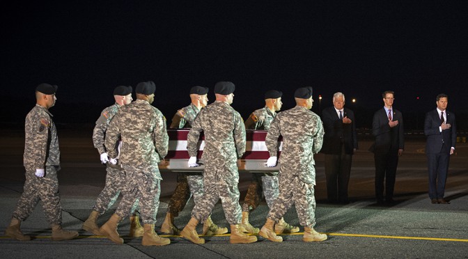 Acting Secretary of the Army Patrick J. Murphy renders honors as a U.S. Army carry team moves the transfer case of U.S. Army Staff Sgt. Matthew McClintock during a dignified transfer Jan. 8 at Dover Air Force Base in Dover, Delaware. McClintock, 30, of Albuquerque, N.M., was assigned to 1st Battalion, 19th Special Forces Group, in Buckley, Wash. Murphy announced Wednesday that McClintock was posthumously promoted. (Department of Defense photo by John G. Martinez)