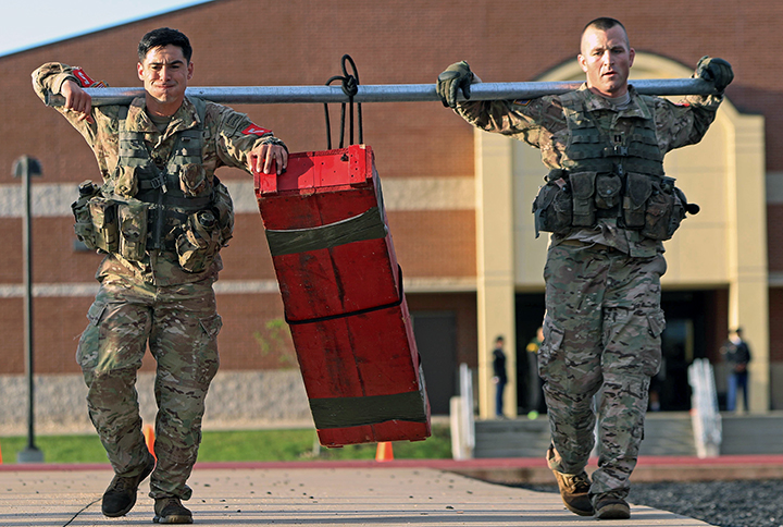 Capt. Jason Bahmer and Sgt. 1st Class David Rizo carry a 250-pound crate during the Best Sapper Competition at Fort Leonard Wood, Mo. (U.S. Army photo by Sgt. Anthony Hewitt)