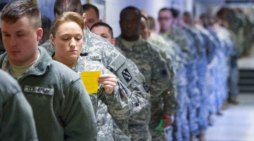 Spc. Shaina Williams, a wheeled vehicle mechanic with H Company, 148th Brigade Support Battalion, Georgia Army National Guard, studies the Creed of the Noncommissioned Officer while she and her classmates stand in line for lunch during Basic Leadership Course at McCrady Training Center in Eastover, S.C. (Photo by Sgt. Brian Calhoun)