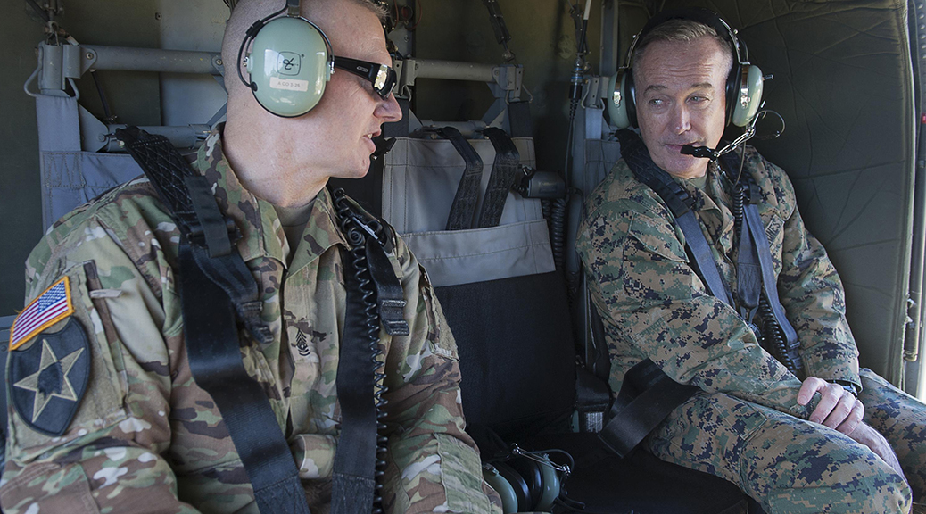 Army Command Sgt. Maj. John W. Troxell, senior enlisted advisor to the chairman of the Joint Chiefs of Staff, speaks to Marine Corps Gen. Joe Dunford, the chairman of the Joint Chiefs of Staff, aboard a UH-60 Black Hawk helicopter in Hawaii. (Photo by Navy Petty Officer 2nd Class Dominique A. Pineiro)