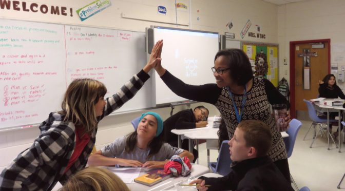 Former NCO and 2017 DODEA Teacher of the Year Kelisa Wing shows students the best websites to research the locations of their parents’ past deployments. (Photo courtesy of DOD Education Activity)