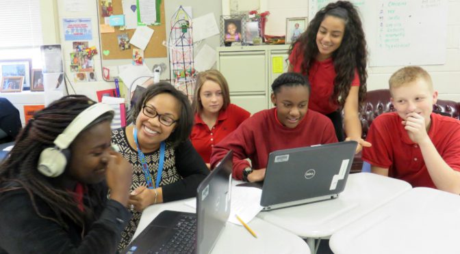 Former NCO and 2017 DODEA Teacher of the Year Kelisa Wing shows students the best websites to research the locations of their parents’ past deployments. (Photo courtesy of DOD Education Activity)