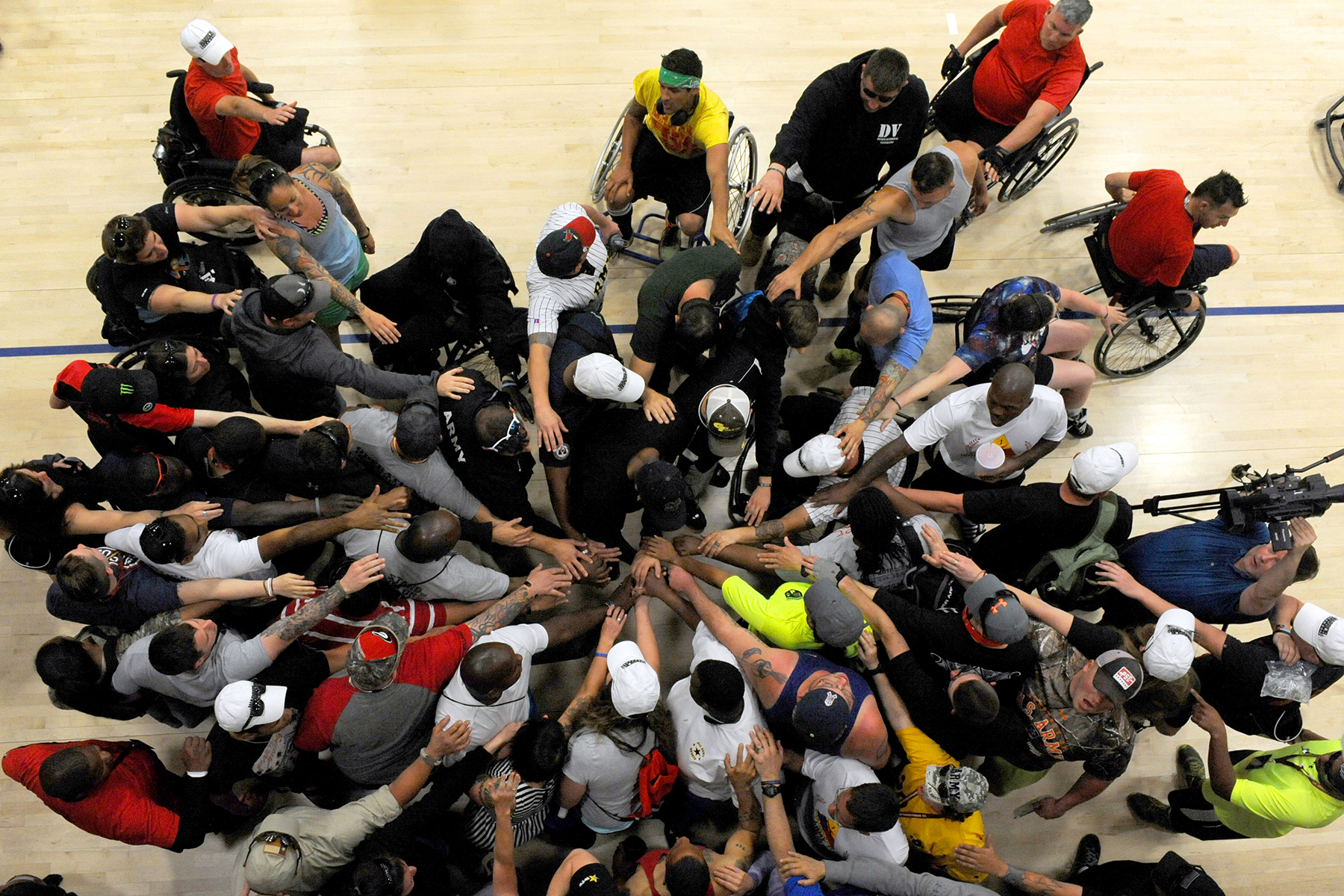 Coaches and athletes huddle before basketball practice during the Army Trials at Fort Bliss in El Paso, Texas, on March 28, 2015. (Photo by EJ Hersom / DoD News)