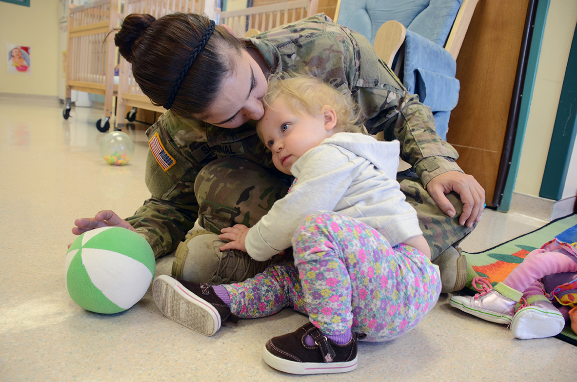 Cpl. Brittany Sandoval of 1st Battalion, 67th Armored Regiment, 3rd Brigade Combat Team, 1st Armored Division plays with her 14-month-old daughter, Piper, before taking her home from a Child Development Center at Fort Bliss, Texas. Like many breastfeeding Soldiers, Sandoval visits the CDC on her lunch break to breastfeed her daughter. (Photo by Meghan Portillo / NCO Journal)