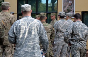 Sgt. 1st Class John C. Hardwick, center, tells NCOs about Sgt. 1st Class Paul Ray Smith before the start of the Noncommissioned Officer Professional Development System training sessions in October at the Army Research Laboratory-Human Research and Engineering Directorate Advanced Training and Simulation Division, Sgt. 1st Class Paul Ray Smith Center University of Central Florida. (Photo by Martha C. Koester / NCO Journal)