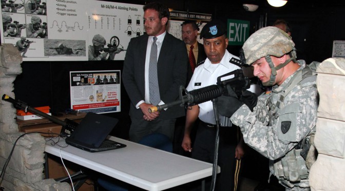 Sgt. 1st Class John C. Hardwick, far right, senior enlisted advisor at the Army Research Laboratory-Human Research and Engineering Directorate Advanced Training and Simulation Division, Sgt. 1st Class Paul Ray Smith Center University of Central Florida, demonstrates an Engagement Skills Trainer prototype for Gen. Dennis Via, commanding general of the U.S. Army Materiel Command during Via’s visit in September to the center. The center is working in collaboration with PEO-STRI on adaptive marksmanship research training using the small arms trainer system, donated by Meggitt. (Photo courtesy of Army Research Laboratory-Human Research and Engineering Directorate Advanced Training and Simulation Division, Sgt. 1st Class Paul Ray Smith Center University of Central Florida)