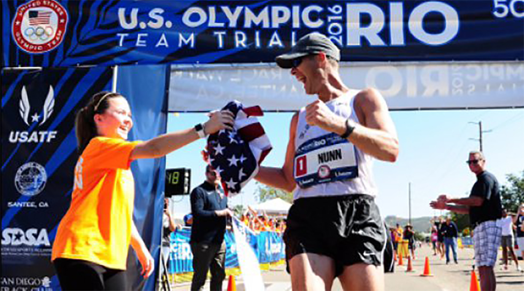 Staff Sgt. John Nunn, a U.S. Army World Class Athlete Program race walker, receives an American flag from his daughter, Ella, after winning the 2016 U.S. Olympic Team Trials for the 50-kilometer race walk Feb. 21, in Santee, California. Nunn, 38, won the event with a personal-best time of 4 hours, 3 minutes, 21 seconds on the 31-mile course to earn his third Olympic berth. (Photo courtesy of Army News Service)