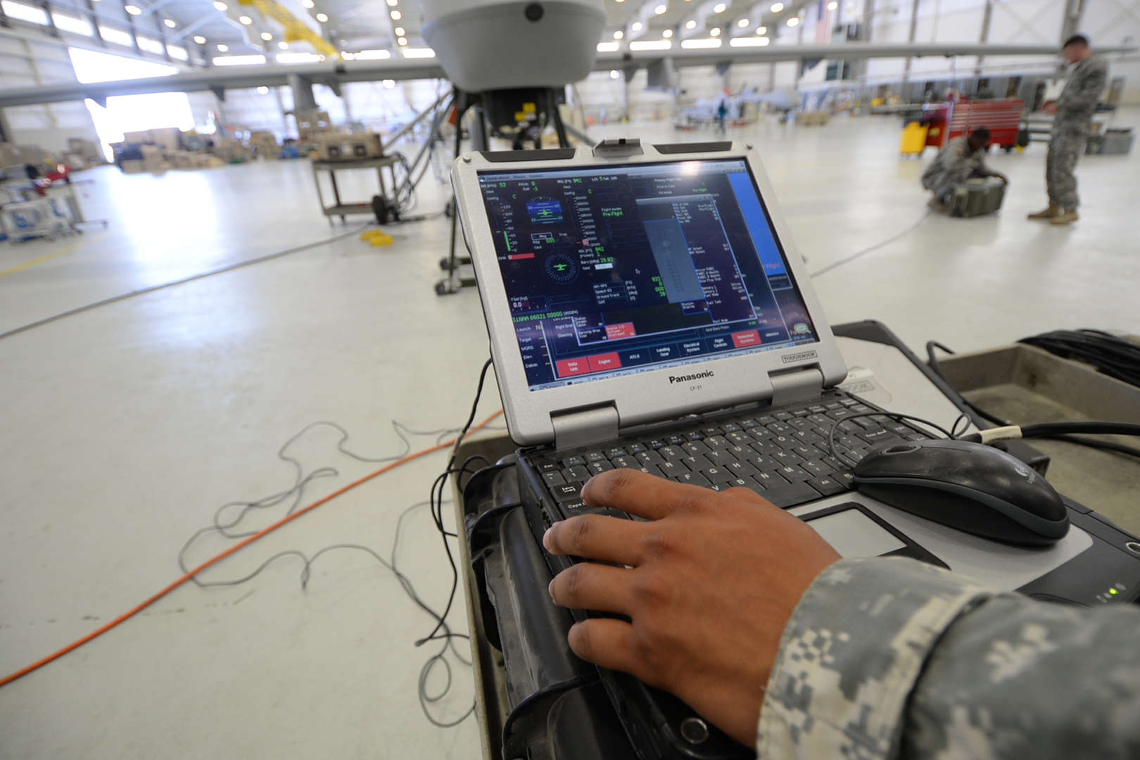 NCOs and junior enlisted connect a portable maintenance aid, or PMA, to the Gray Eagle UAVs to monitor preflight operational checks. (Photo by Meghan Portillo/NCO Journal)