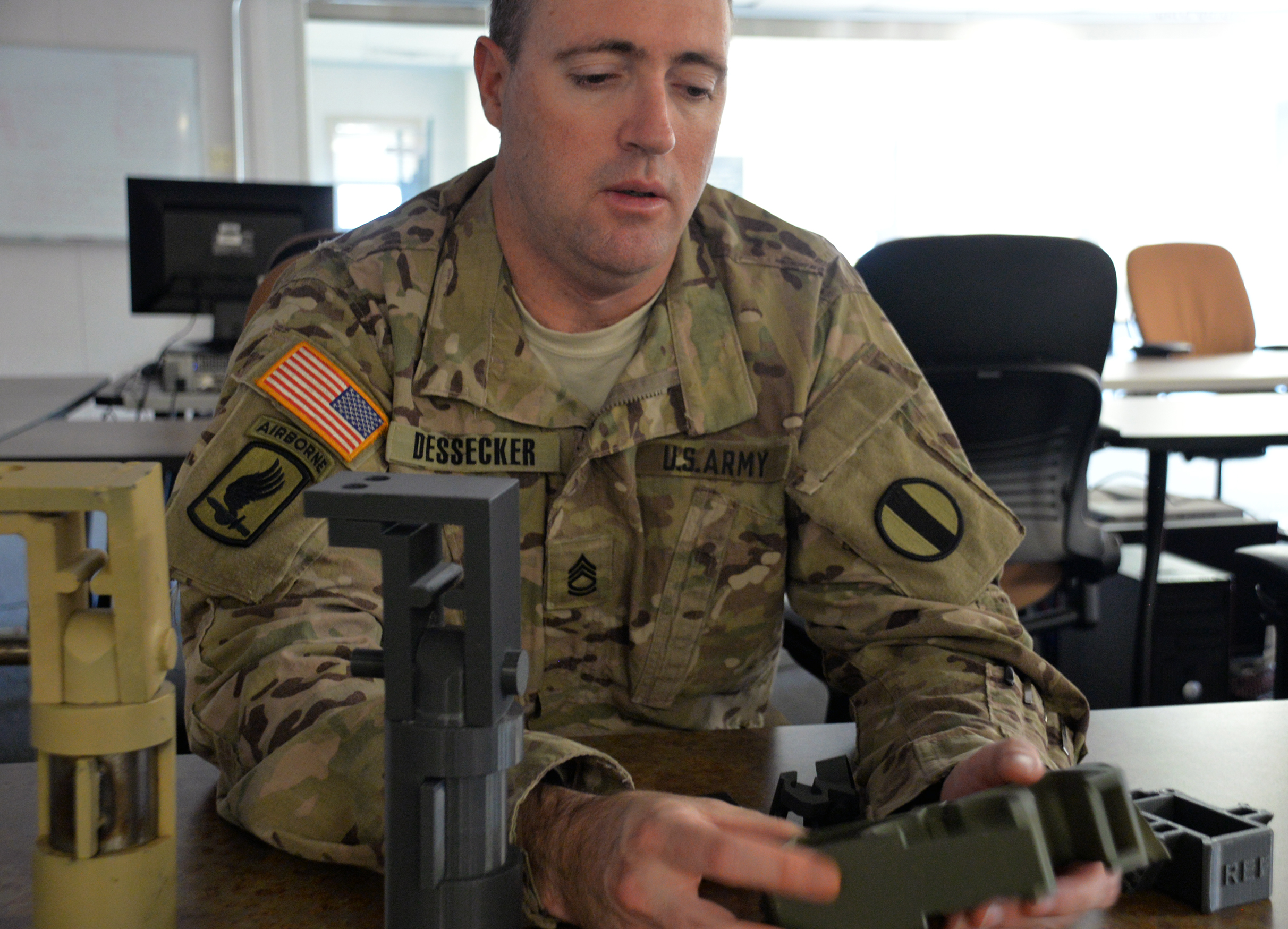 Sgt. 1st Class Michael Wayne Dessecker, an operational advisor for the Rapid Equipping Force’s outreach team, says Ex Lab projects are often first developed into a working plastic version from 3D printers in order to cut down costs and to check its form, fit and function. (Photo by Martha C. Koester / NCO Journal)