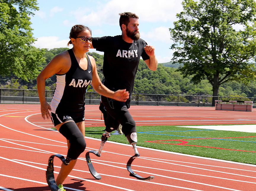 U.S. Army veteran Sgt. Ana Manciaz of Los Lunas, N.M., and U.S. Army veteran Sgt. Stefan LeRoy of Santa Rosa, Calif., run track at Shea Stadium in preparation for the 2016 Defense Department Warrior Games. (DoD photo)
