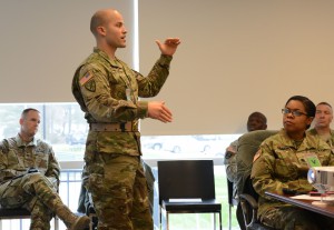 Staff Sgt. Jacob Miller, the 2015 Drill Sergeant of the Year, discusses how lack of sleep degrades performance. He spoke during the Army Office of the Surgeon General-sponsored Performance Triad Sleep Summit, Dec. 9, 2015. (Photo by David Vergun / Army News Service)